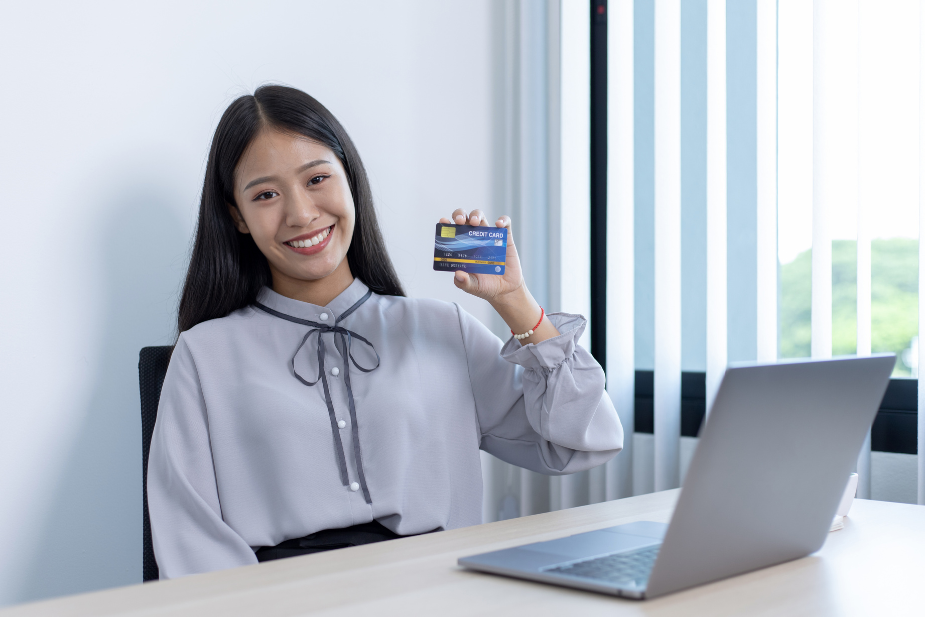 Woman Holding a Credit Card