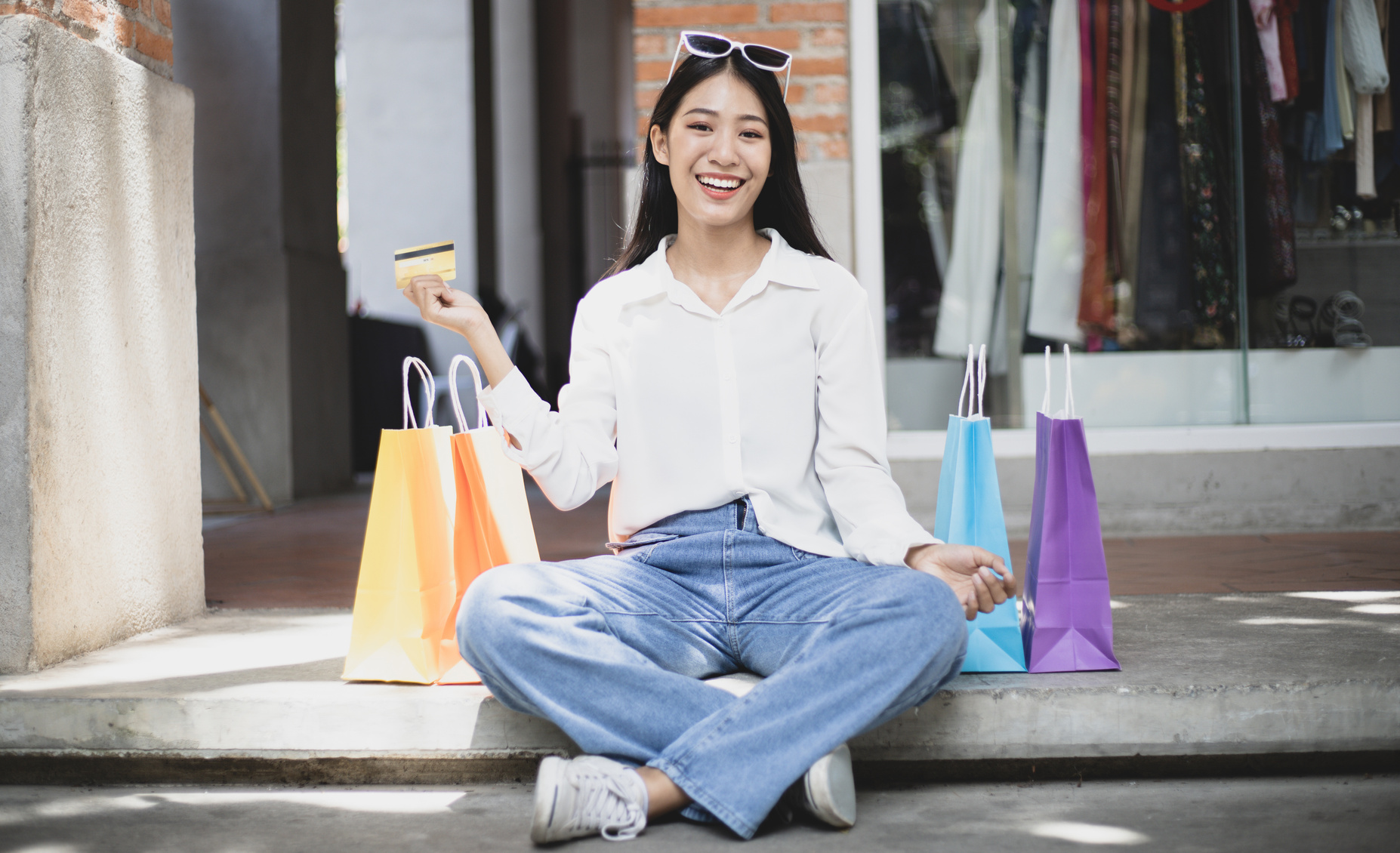 Woman with Shopping Bags Outdoors with Credit Card