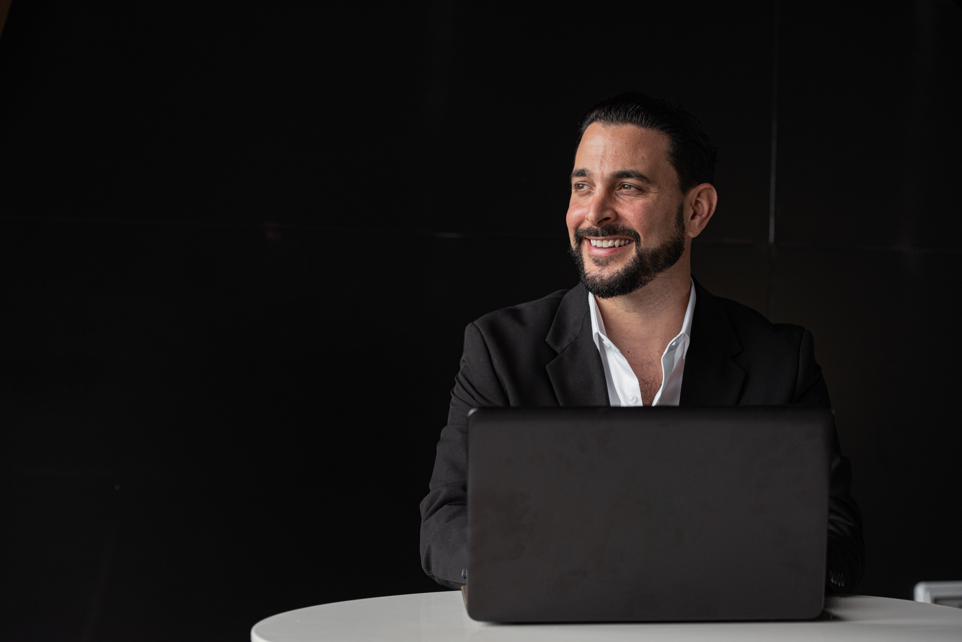 Portrait of handsome businessman using laptop computer