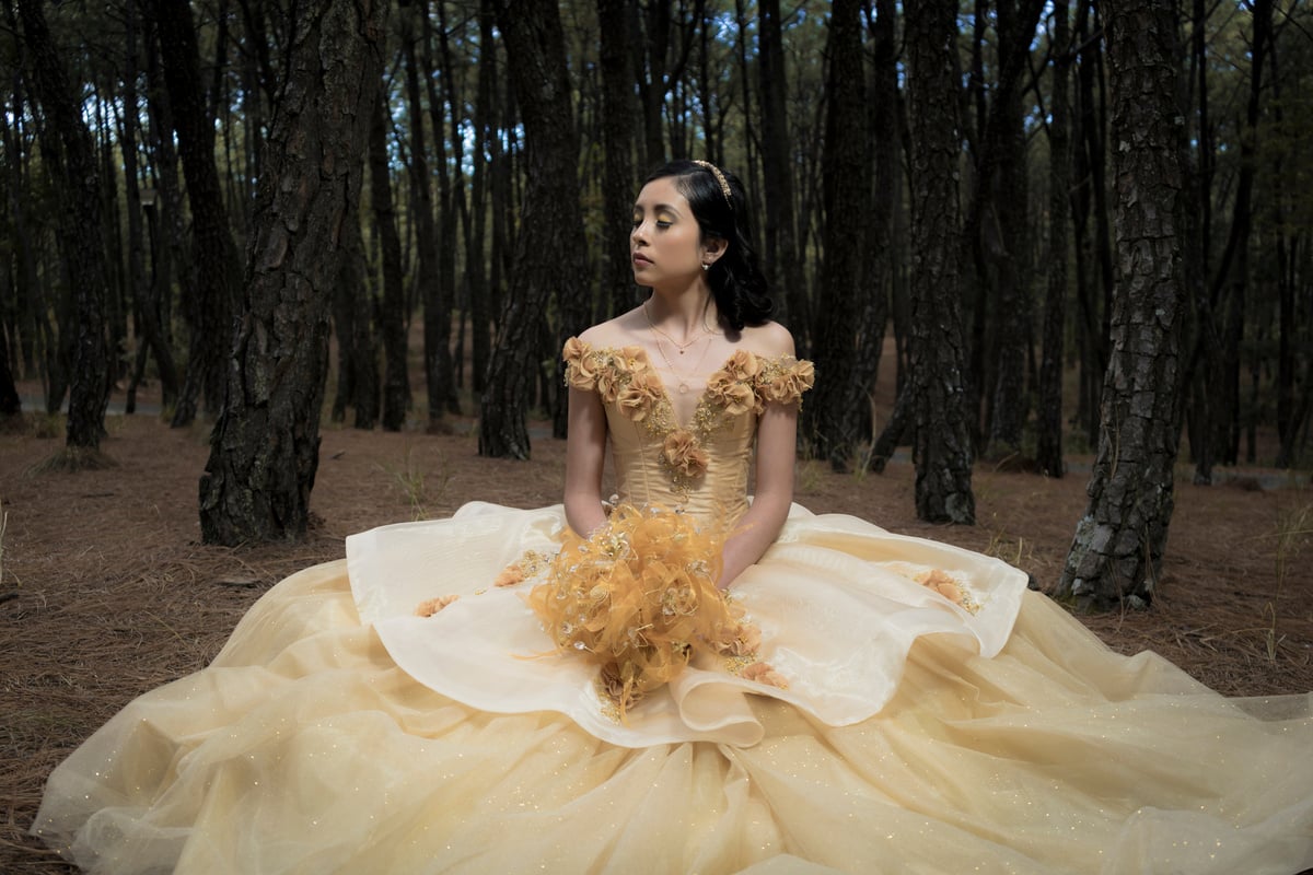 Female Teenager Wearing Her Yellow Ball Gown in the Forest