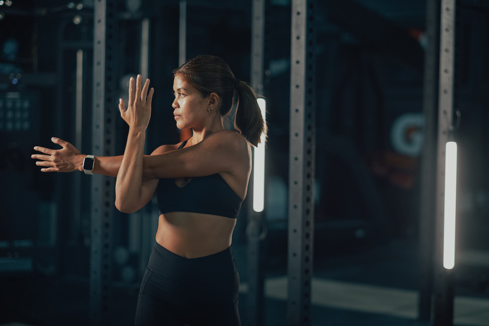 Female Trainers and Weightlifting Woman Stretching in a Gym